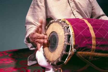 Photo for Man playing musical instrument mridangam India - Royalty Free Image