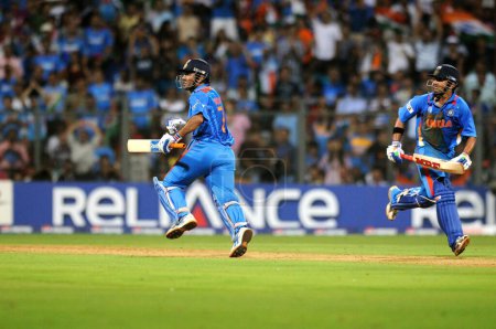 Photo for Indian batsman L Gautam Gambhir, MS Dhoni running between wickets during the 2011 ICC World Cup Final between India and Sri Lanka at Wankhede Stadium on April 2 2011 in Mumbai India - Royalty Free Image