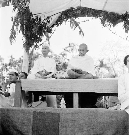Photo for Thakkar Bapa and Mahatma Gandhi at a prayer meeting during Mahatma Gandhi visit of the riot affected areas of Noakhali East Bengal, November 1946, India - Royalty Free Image