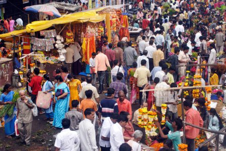 Téléchargez les photos : Foule dans le marché aux fleurs achetant des articles utilisés pour décorer les idoles de Lord Ganesh, célébrant le festival Ganapati à Dadar, Bombay Mumbai, Maharashtra, Inde - en image libre de droit