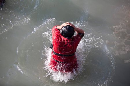 Photo for Devotee taking dip in Ganga river at Haridwar Uttarakhand India Asia - Royalty Free Image