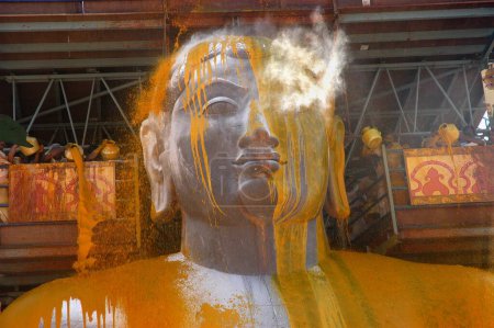 Photo for Turmeric covered face of 57 feet high statue of lord Bahubali known as Gomateshvara in Mahamasthakabisheka celebration, Sravanabelagola in Hassan district of Karnataka, India - Royalty Free Image