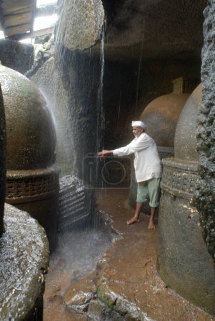 Man enjoying water flowing ; Bhaja caves ; Maharashtra ; India