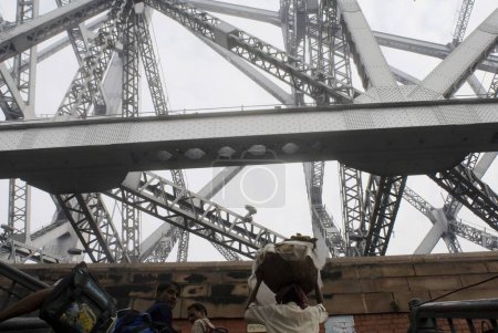Photo for Howrah Bridge (Rabindra Setu)  A miracle of engineering skill  ; Huge cantilever and wide bridge ; Kolkata  ; West Bengal  ; India - Royalty Free Image