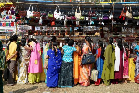 Photo for Women crowding at the only bags counter at the fair, India - Royalty Free Image