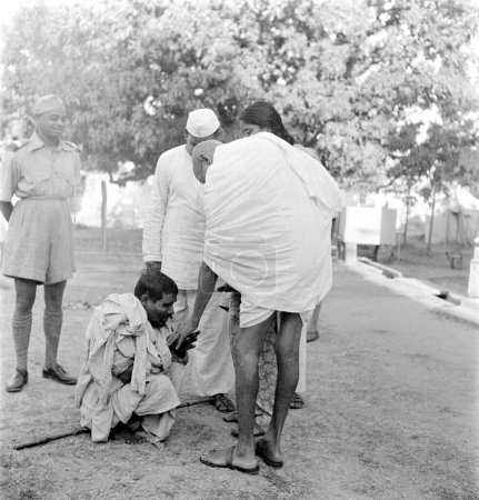 Photo for Mahatma Gandhi talking to a blind villager in Bihar, India, March 1947 - MODEL RELEASE NOT AVAILABLE - Royalty Free Image