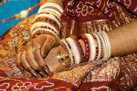 Photo for Bride showing bangles and henna tattoos in marriage ceremony - Royalty Free Image
