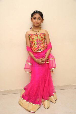 girl wearing pink ghagra choli dress, India, Asia