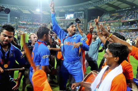 Photo for Indian players L Virat Kohli Suresh Raina Harbhajan Singh dance during the victory lap after India defeated Sri Lanka in the ICC Cricket World Cup 2011 final played at the Wankhede Stadium in Mumbai India on April 2 2011 - Royalty Free Image