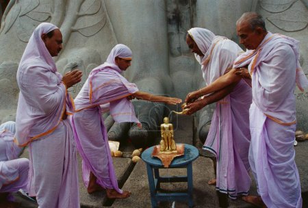 Photo for Jain sadhus pouring water on miniature statue of jain saint Gomateshwara in Shravanbelagola, Karnataka, India - Royalty Free Image