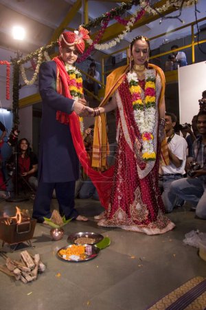 Téléchargez les photos : Mariée indienne et marié tenant la main prenant autour du feu sacré dans la cérémonie de mariage - en image libre de droit