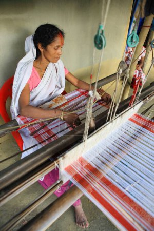 Photo for Woman weaving on handloom, Assam, India - Royalty Free Image