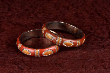 Photo for Indian Lac bangles. Bracelet with diamonds and stones on a textured background, Indian Traditional Jewellery, Style, fashion and design of jewelry - Royalty Free Image