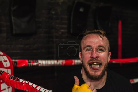 Photo for Portrait of a mma fighter smiling with mouthguard on after a fight. - Royalty Free Image
