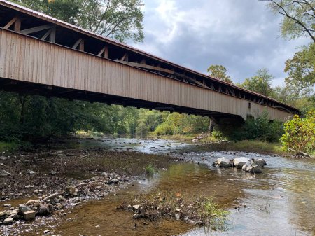 The Academia Pomeroy Covered Bridge at 278-foot-long (85 m)  is the longest remaining covered bridge in Pennsylvania. Listed on the National Register of Historic Places in 1979.  single-lane, double-span wooden covered bridge. Rural scene in fall