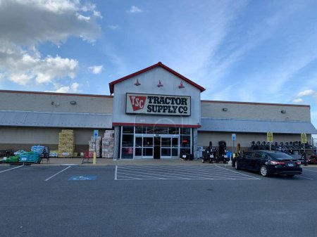 Photo for New Holland, USA, October 5, 2023: Tractor supply Co store in Lancaster County, PA. Blue sky with clouds. Goods stocked up in front of shop. One car parking. Open sign - Royalty Free Image