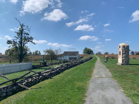 Weg auf dem Schlachtfeld im Gettysburg National Military Park an einem sonnigen Tag im Frühherbst, bewölkt. Denkmäler, Markierungen und Zäune. Die Schlacht von Gettysburg war ein Wendepunkt im Bürgerkrieg.