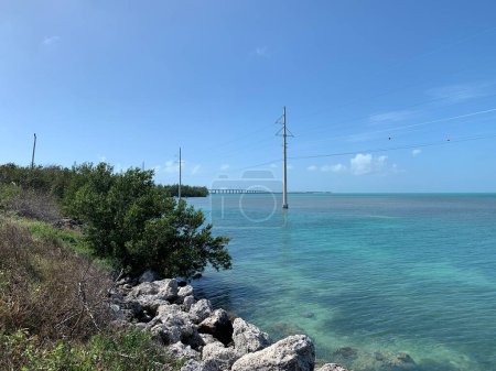 Florida Keys, landscape at shore besides Overseas Highway, View of bridge, sea and electric poles