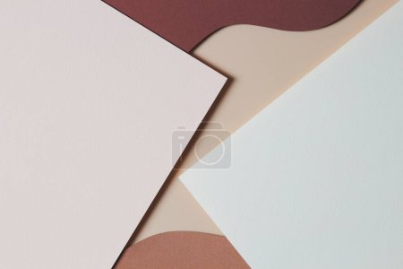Abstract colored paper texture background. Minimal paper cut style composition with layers of geometric shapes and lines in shades of beige and brown colors. Top view, copy space