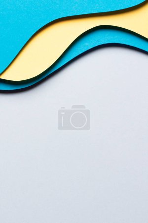 Photo for Abstract colored paper texture background. Minimal paper cut composition with layers of geometric shapes and lines in yellow and light blue colors. Top view. - Royalty Free Image