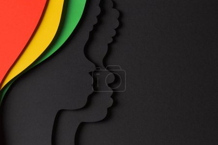 Black History Month color background. African Americans history celebration. Black paper cut people silhouette on abstract geometric shape red, yellow, green, black color background. Top view.