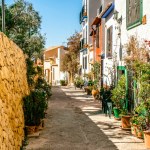 Finestrat, Alicante province, Spain. Beautiful quiet narrow street of small Finestrat village old town at sunny day.