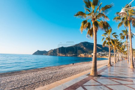 Photo for View to beautiful Albir town with main boulevard promenade, seaside beach and Mediterranean sea. Albir is small resort city between Altea and Benidorm, Alicante province, Spain. - Royalty Free Image