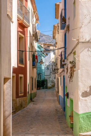 Photo for Finestrat, Alicante province, Spain. Beautiful quiet narrow street of small Finestrat village old town on sunny day. - Royalty Free Image
