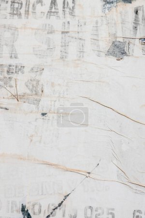 Old grunge torn collage urban street posters creased crumpled paper placard texture background. Ripped faded paper backdrop surface placard.