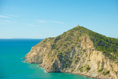 Photo for Panoramic view to Mediterranean sea and cliffs with watchtower Torre del Aguilo on a sunny day. - Royalty Free Image