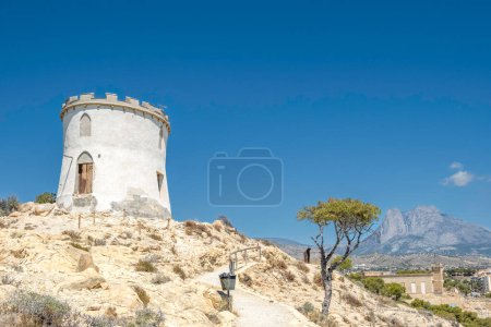 Photo for Beautiful Villajoyosa town in Spain. View from clifftop at Malladeta in La Vila Joiosa to the Tower Malladeta, Villa Giacomina and Puig Campana mountain in the distance. - Royalty Free Image