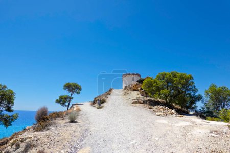 Photo for Beautiful Villajoyosa town in Spain. View to clifftop Malladeta in La Vila Joiosa to the Tower Malladeta. - Royalty Free Image