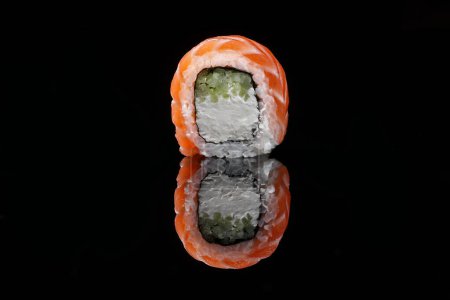 Foto de Filadelfia rollos de sushi con salmón sobre un fondo negro con reflejo - Imagen libre de derechos