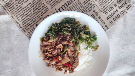 rice with beef and mustard on white plate