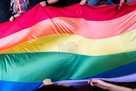 Photo for People demonstrating on Pride Day with pride flag - Royalty Free Image