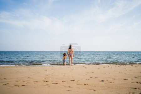 Photo for Mother and son holding hands looking at the atlantic ocean - Royalty Free Image