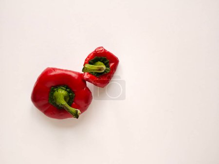 Red bell pepper cut in half. Pepper's parts with seeds. Light background with copy space. Garbage food.