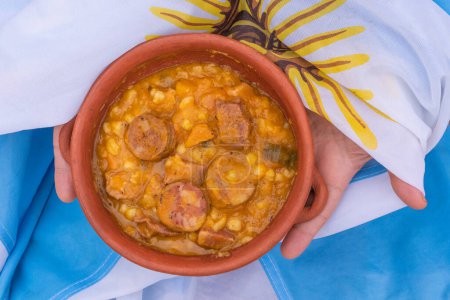 CASSEROLE OF A TYPICAL STEW FROM THE ANDEAN REGION, CALLED LOCRO, ON AN ARGENTINE FLAG.