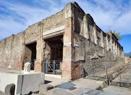 Photo for Pompeii, Campania, Italy - October 14, 2021: Building of Eumachia overlooking the Piazza del Foro and Via dell'Abbondanza in the Archaeological Park of Pompeii - Royalty Free Image