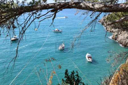 Photo for Sperlonga, Lazio, Italy  September 5, 2021: Boat of tourists at the Grotta della Madonnina from the hillside path that connects the Piana di Sant'Agostino with the Baia delle Sirene - Royalty Free Image