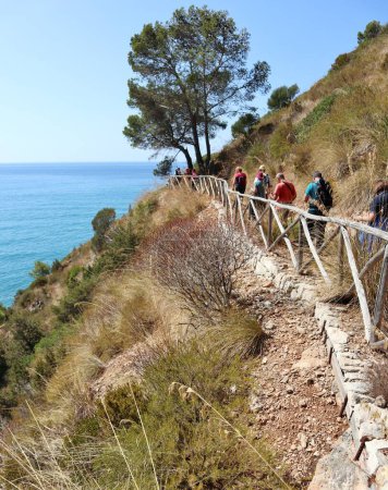 Photo for Gaeta, Lazio, Italy  September 5, 2021: Hikers on the hillside path that connects the Piana di Sant'Agostino with the Baia delle Sirene - Royalty Free Image