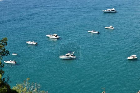 Photo for Sperlonga, Lazio, Italy  September 5, 2021: Boats of tourists at Baia delle Sirene from the mid-coast path - Royalty Free Image