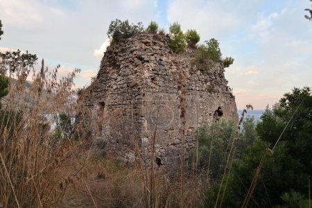 Photo for Marina del Cantone - 4 September 2023: Ruins of the Recommone Tower built in the 16th century along the coastal path that connects the Marina del Cantone beach with the Recommone beach - Royalty Free Image