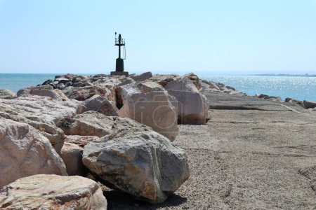 Termoli, Molise, Italy  12 April 2024: Promenade of the Port along the breakwater that from Viale dei Trabucchi reaches the lighthouse
