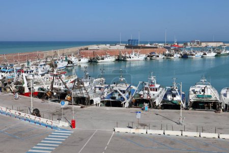 Termoli, Molise, Italy  12 April 2024: The port of Termoli, close to the Borgo Antico, characterized by a pier for fishing boats and the Guardia di Finanza, an intermediate pier for boarding for the Tremiti Islands, and the shipyard pier at the north