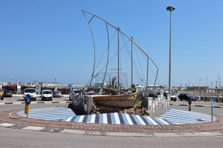 Photo for Termoli, Molise, Italy  12 April 2024: Monument to the Paranze, the typical trawling boats, decorated with 21 porcelain stoneware tiles on the port roundabout - Royalty Free Image