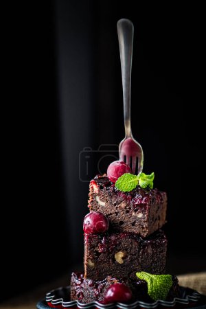 Photo for Fork.chocolate brownie cake decorated with berries and chocolate. - Royalty Free Image