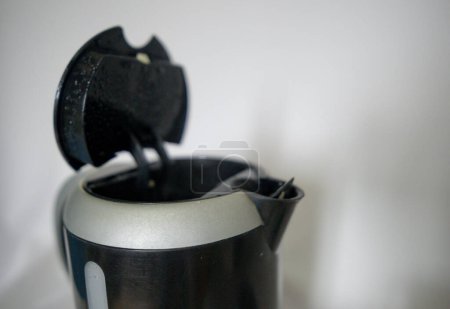 Hand holding a medium-sized electric kettle