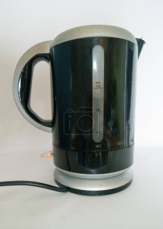 Hand holding a medium-sized electric kettle