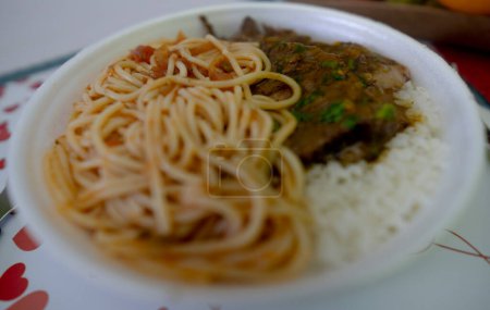 Photo for Rice, beans, steak and pasta this is traditional warm or marmitex as it is well known in Brazil - Royalty Free Image